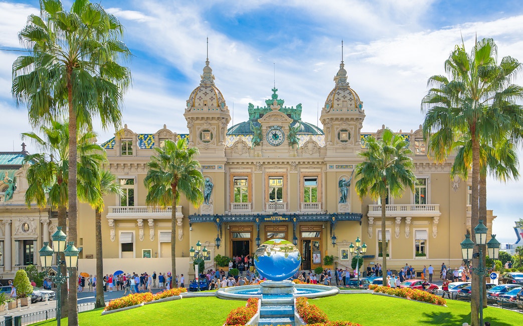 Grand Casino Monte Carlo exterior with ornate architecture and luxury cars, popular tourist attraction.