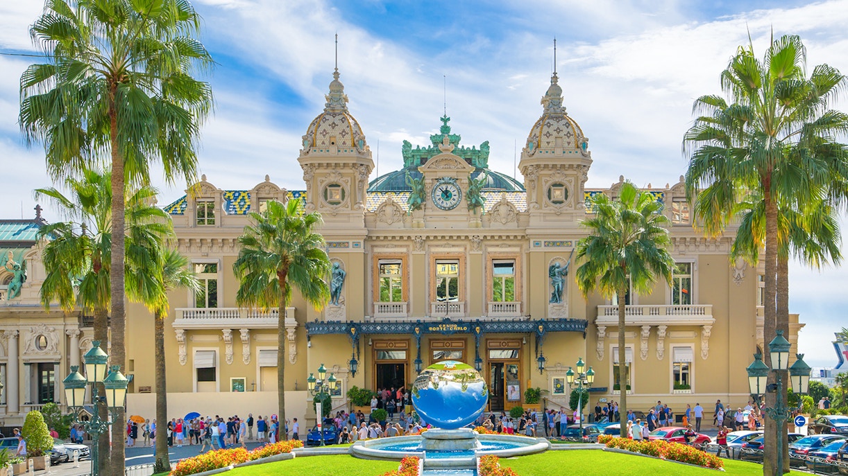 Grand Casino Monte Carlo exterior with ornate architecture and luxury cars, popular tourist attraction.