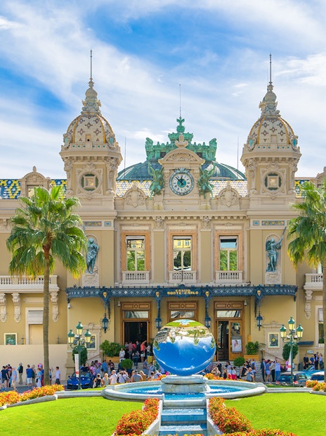 Grand Casino Monte Carlo exterior with ornate architecture and luxury cars, popular tourist attraction.