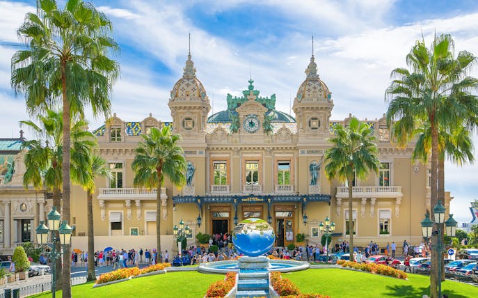 Grand Casino Monte Carlo exterior with ornate architecture and luxury cars, popular tourist attraction.