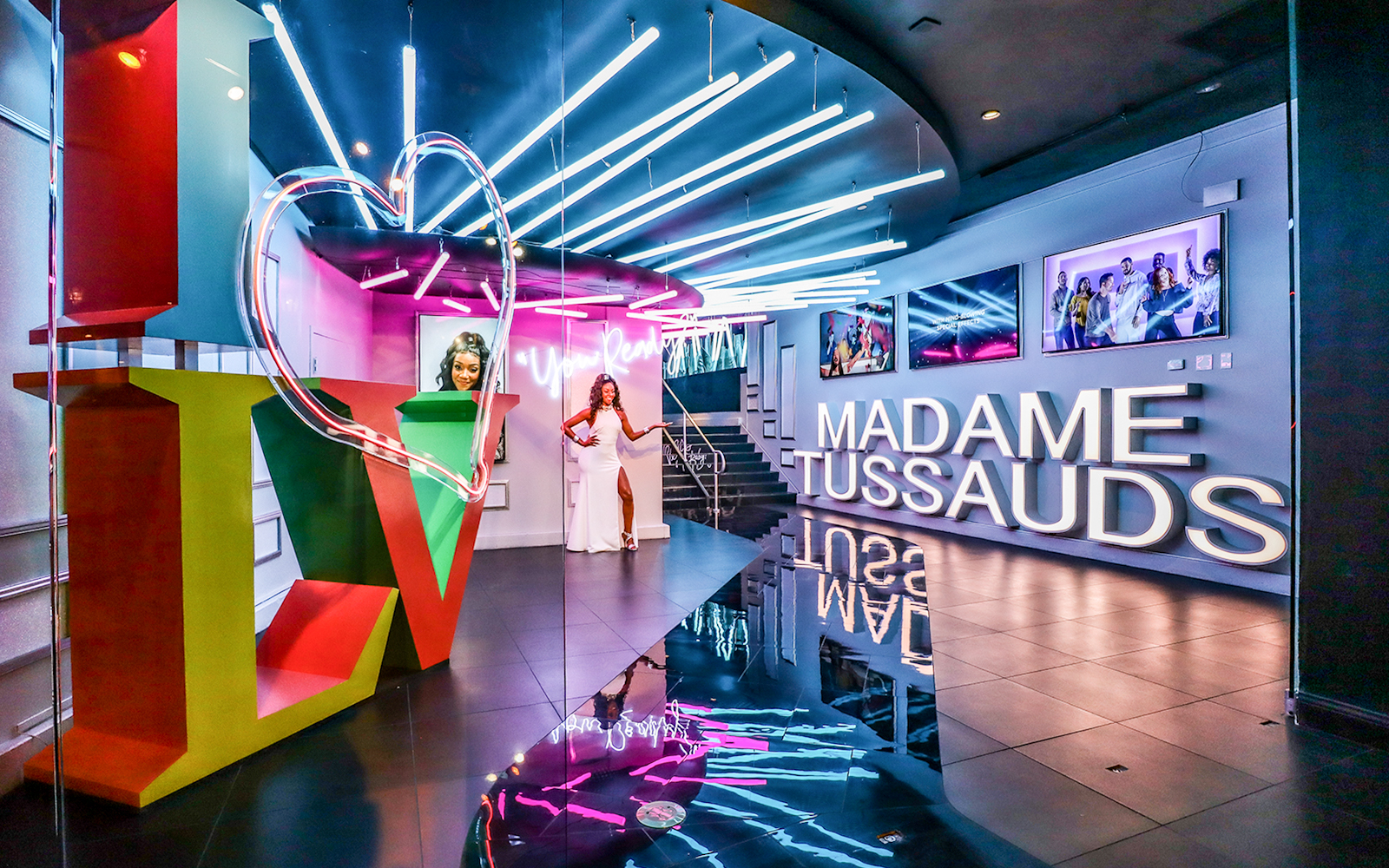Madame Tussauds Las Vegas entrance with neon lights and wax figure display.