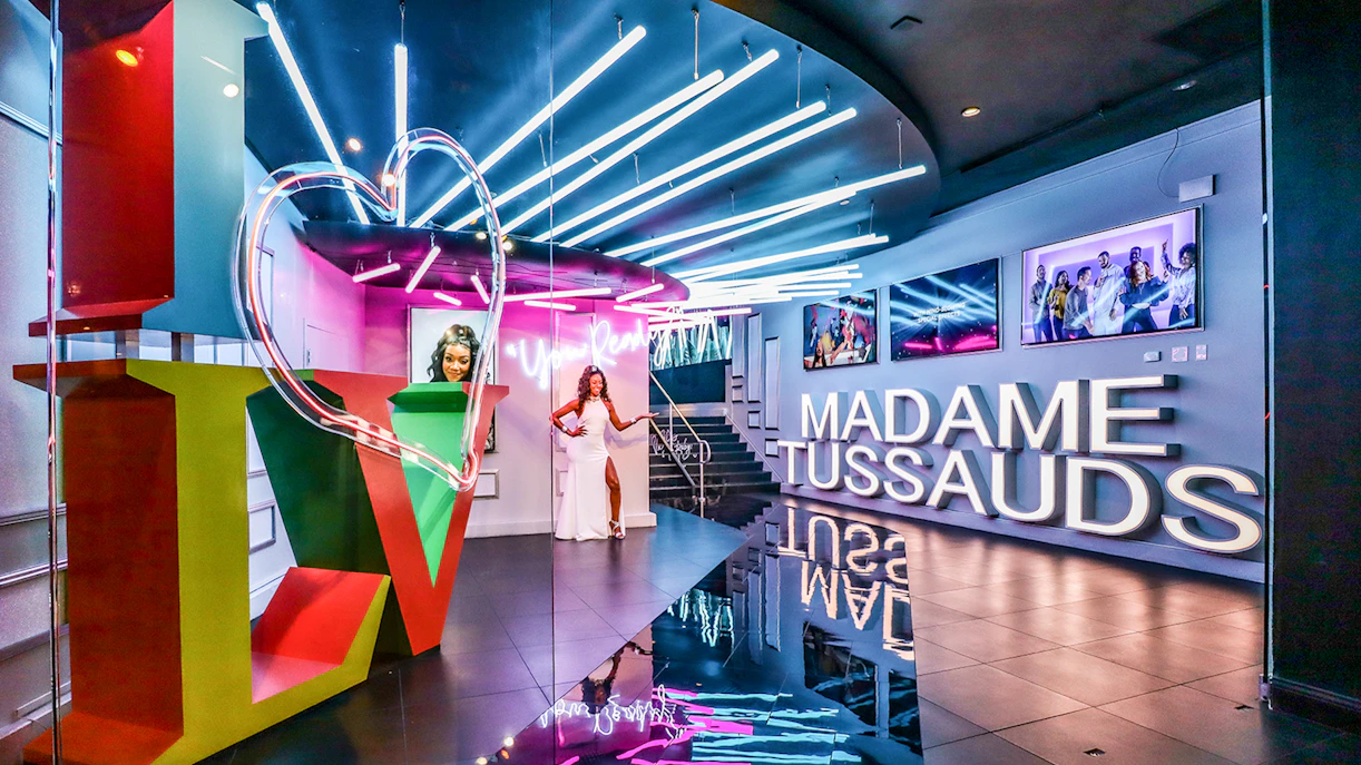 Madame Tussauds Las Vegas entrance with neon lights and wax figure display.