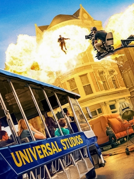 Universal Studios Hollywood tram tour with explosion and film crew on set.