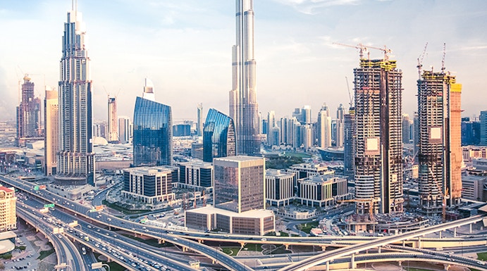 Burj Khalifa towering over Dubai skyline with intricate highway network below.