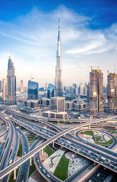 Burj Khalifa towering over Dubai skyline with intricate highway network below.