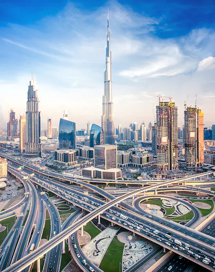 Burj Khalifa towering over Dubai skyline with intricate highway network below.