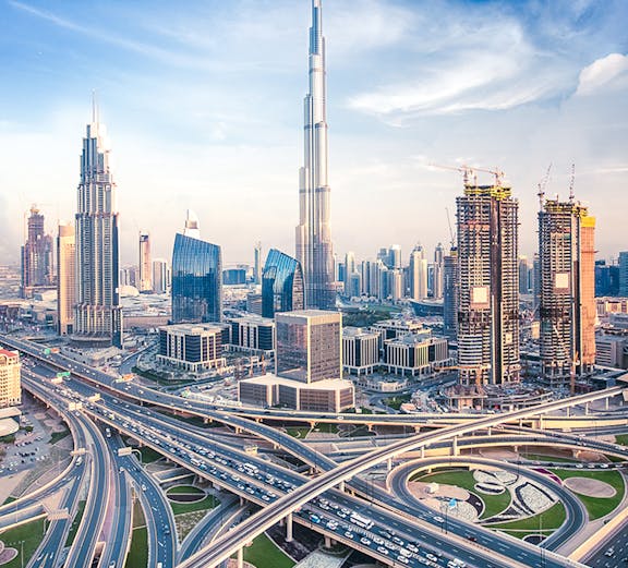 Burj Khalifa towering over Dubai skyline with intricate highway network below.
