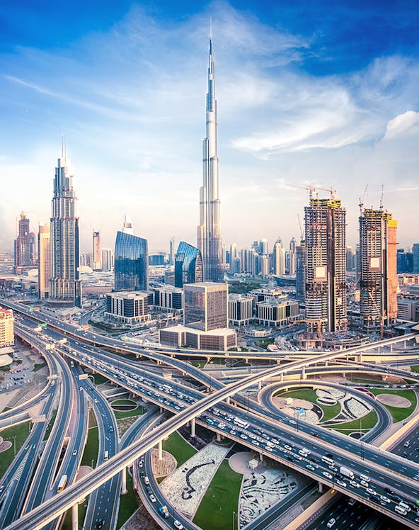 Burj Khalifa towering over Dubai skyline with intricate highway network below.