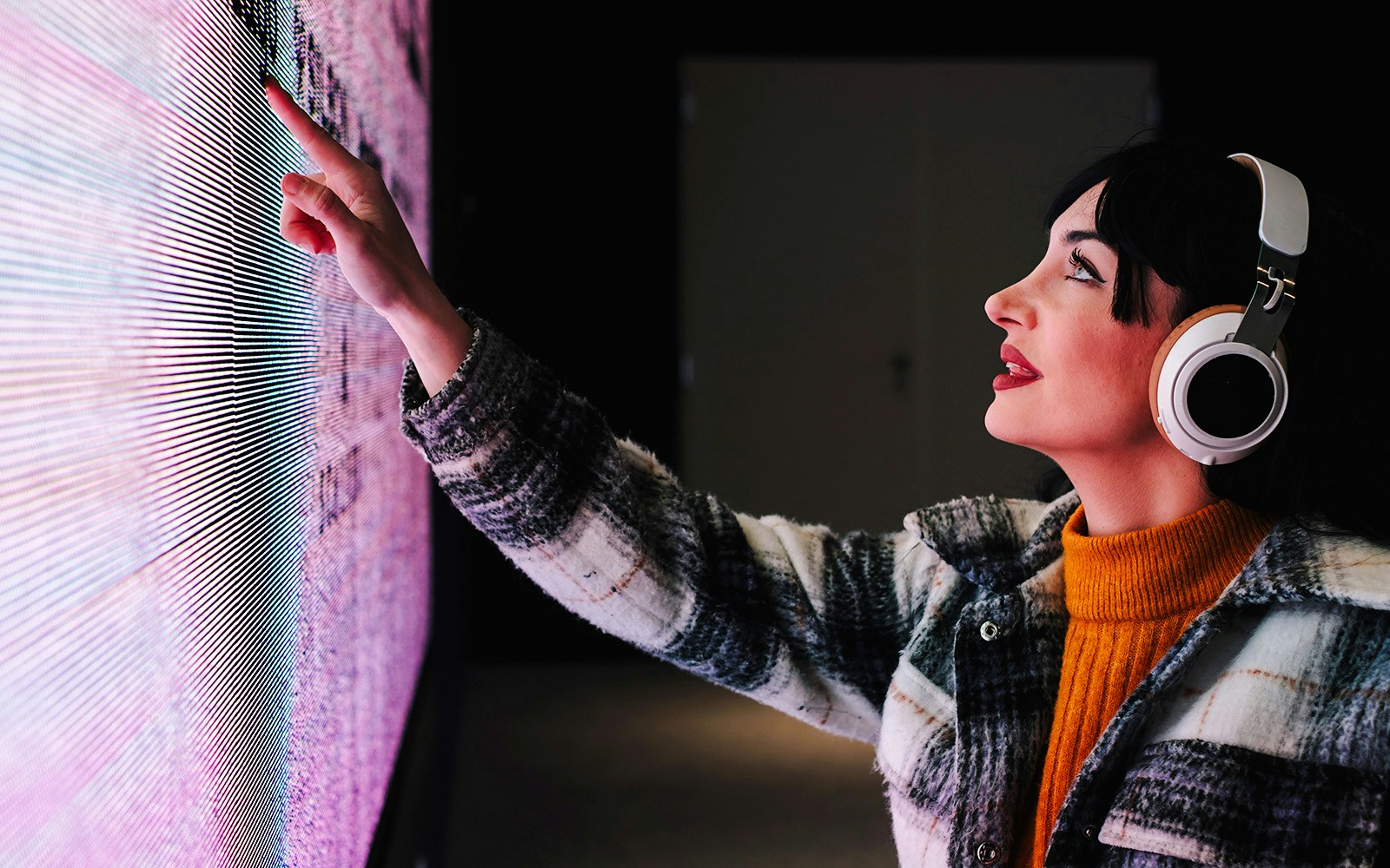 User engaging with interactive touchscreen art exhibit.