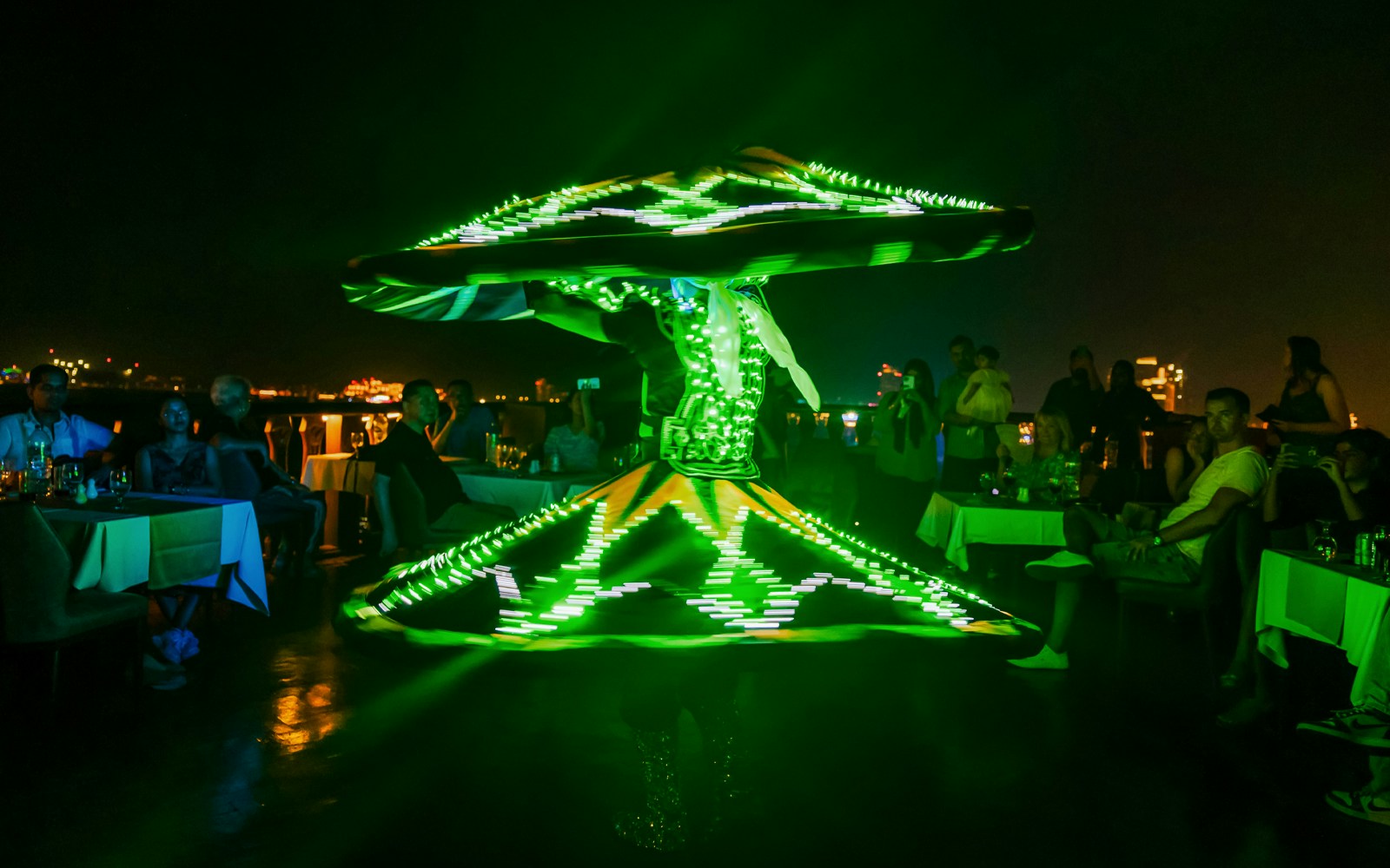 Tanoura dancer performing with illuminated costume on Alexandra VIP Dhow Cruise.