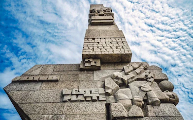 Westerplatte Monument in Gdansk, Poland, featuring carved stone figures and inscriptions.