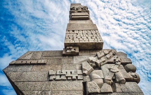 Westerplatte Monument in Gdansk, Poland, featuring carved stone figures and inscriptions.