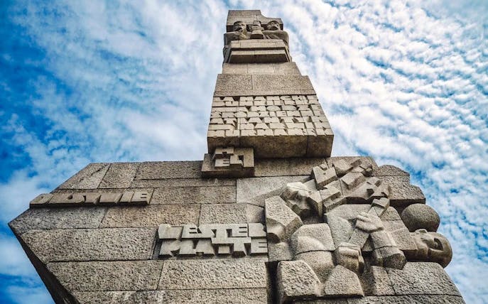 Westerplatte Monument in Gdansk, Poland, featuring carved stone figures and inscriptions.
