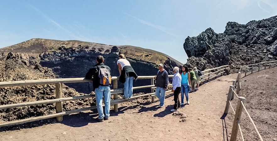 Tourists walking along a hiking trail at Mount Vesuvius, Italy.