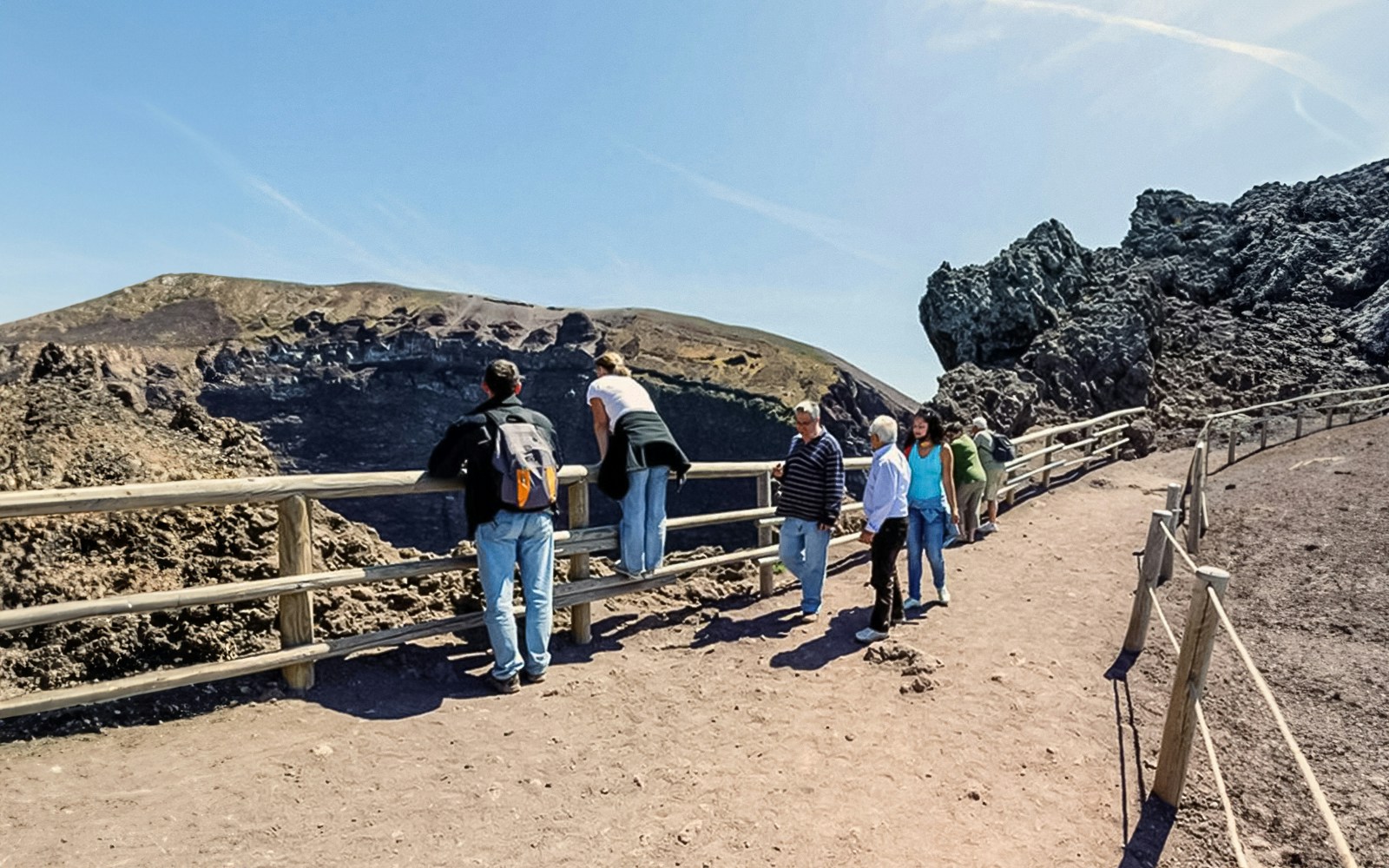 Tourists walking along a hiking trail at Mount Vesuvius, Italy.