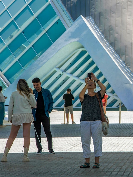 Visitors at Hemisfèric in Valencia, Spain, capturing photos of the modern architecture.