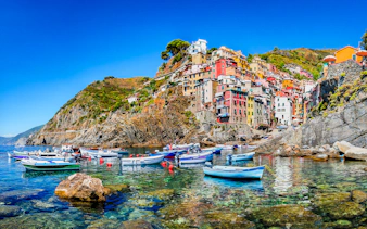 Colorful buildings and boats in Riomaggiore, Cinque Terre, Italy.