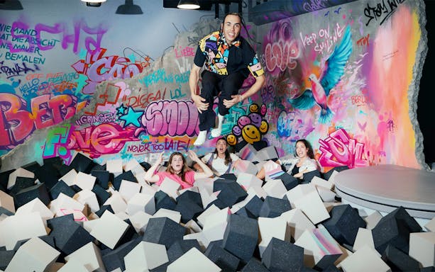 Visitors enjoying foam pit and graffiti art at The Upside Down Berlin.
