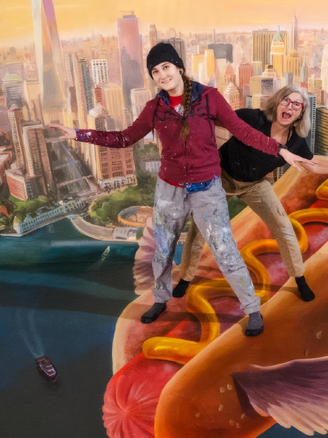 Guests posing on a flying hot dog at TiLT Interactive Museum, American Dream.