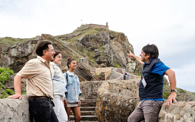 Tour group exploring San Juan de Gaztelugatxe near Bilbao.
