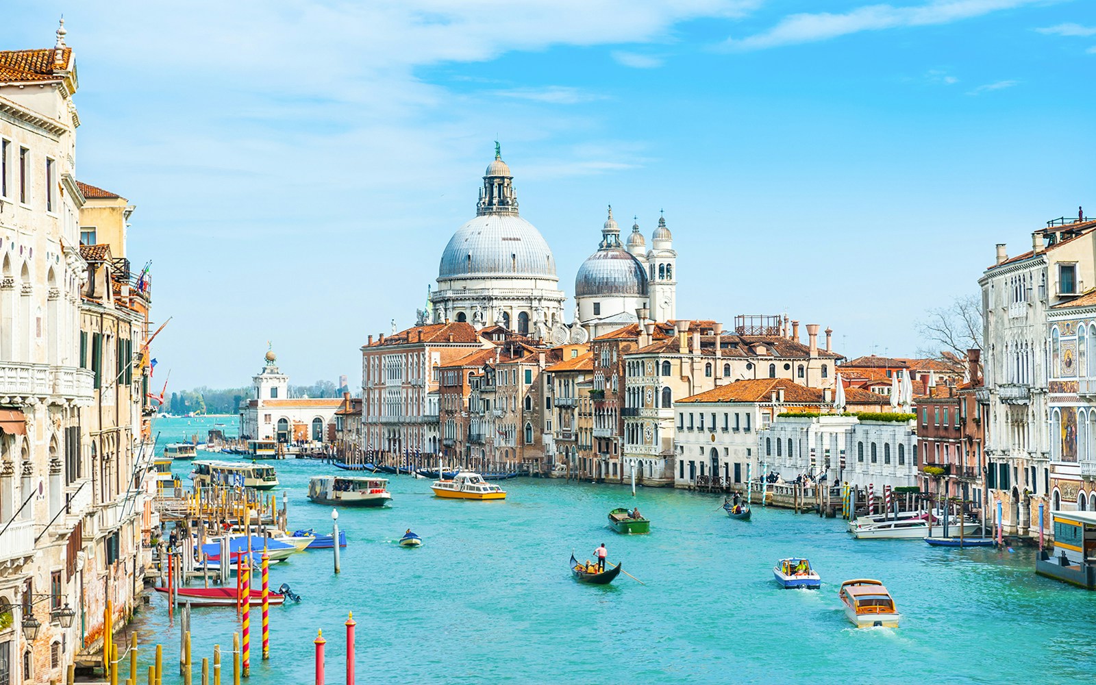 Grand Canal in Venice with gondolas and Santa Maria della Salute in the background.