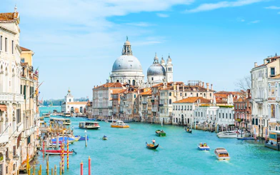 Grand Canal in Venice with gondolas and Santa Maria della Salute in the background.