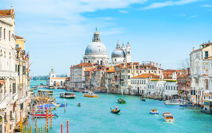 Grand Canal in Venice with gondolas and Santa Maria della Salute in the background.