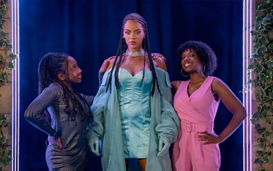Rihanna wax figure with visitors at Madame Tussauds London.