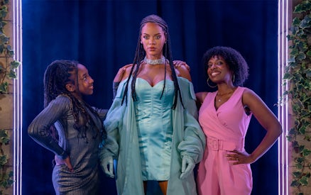 Rihanna wax figure with visitors at Madame Tussauds London.