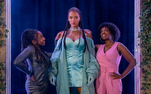 Rihanna wax figure with visitors at Madame Tussauds London.