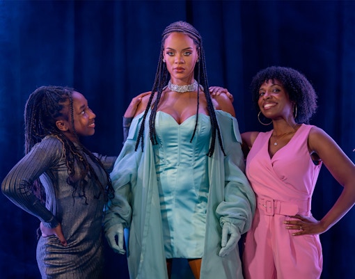 Rihanna wax figure with visitors at Madame Tussauds London.