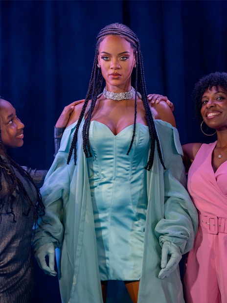 Rihanna wax figure with visitors at Madame Tussauds London.