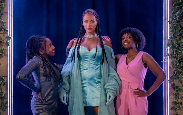 Rihanna wax figure with visitors at Madame Tussauds London.