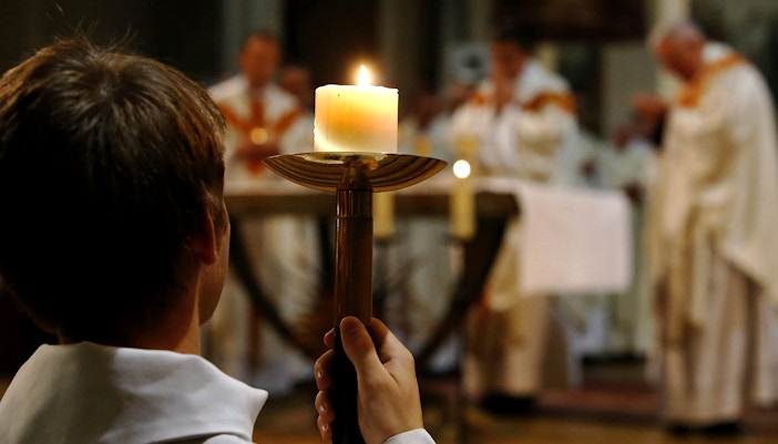 Notre Dame Cathedral interior during mass, Paris, France.