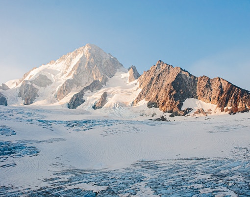 Snow-covered Mont Blanc massif in the French Alps under a clear blue sky.