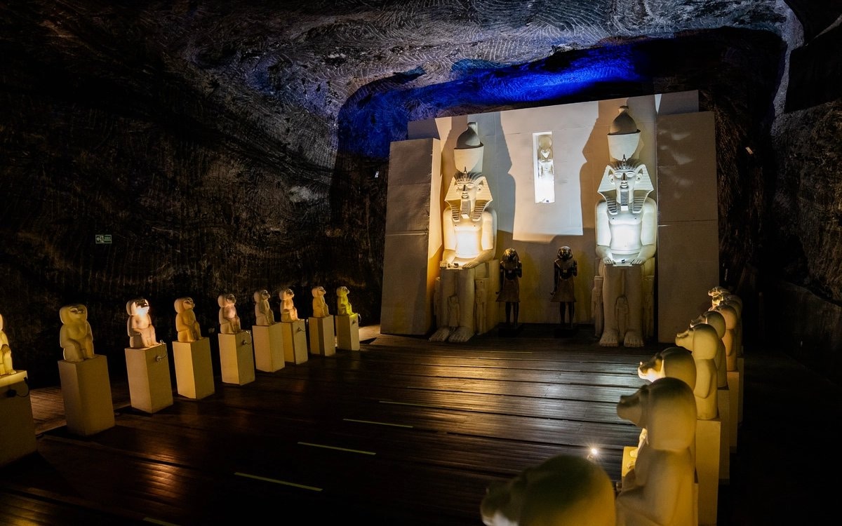 Salt Cathedral of Zipaquirá interior with Tutankhamun statues and illuminated carvings.
