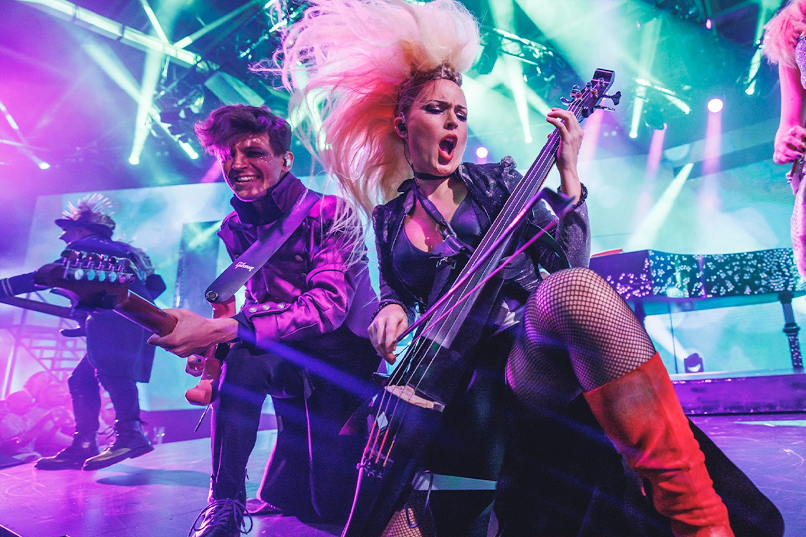 Musicians performing energetically on stage with vibrant lighting at WAH event.