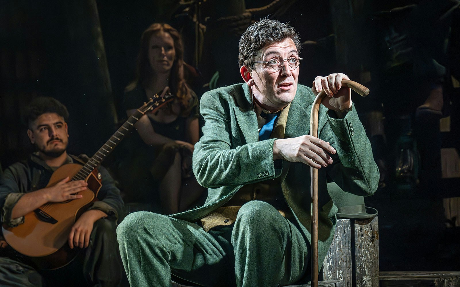 Actor in green suit with cane on stage during "The Curious Case of Benjamin Button - The Musical.