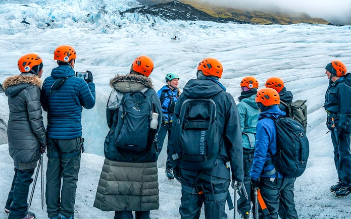 Tour guide explaining to guests during Blue Ice Cave & Glacier Hike on Vatnajökull from Skaftafell.