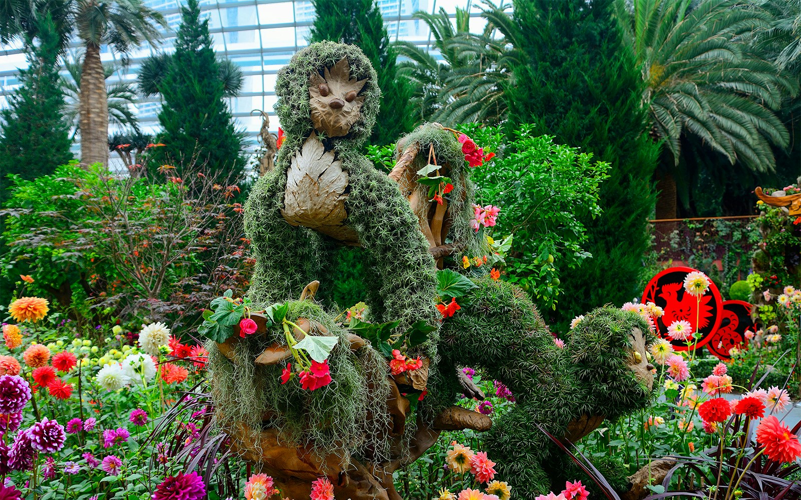 Topiary sculpture surrounded by vibrant flowers at Floral Fantasy, Singapore.