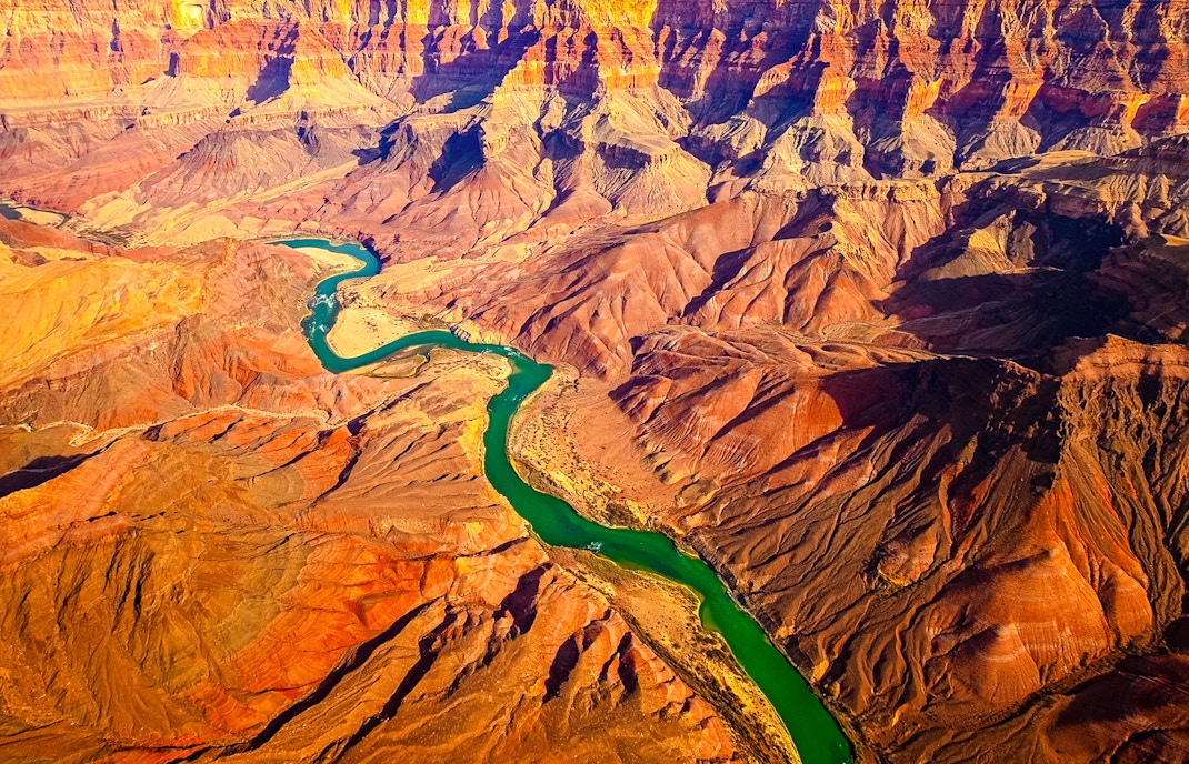 Curved Colorado River flowing through Grand Canyon, USA, showcasing panoramic landscape view.