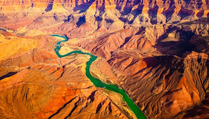 Curved Colorado River flowing through Grand Canyon, USA, showcasing panoramic landscape view.