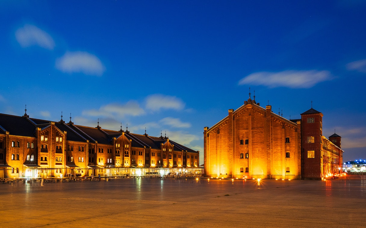 Yokohama Red Brick Warehouse illuminated at night, part of Kamakura Yokohama tour.