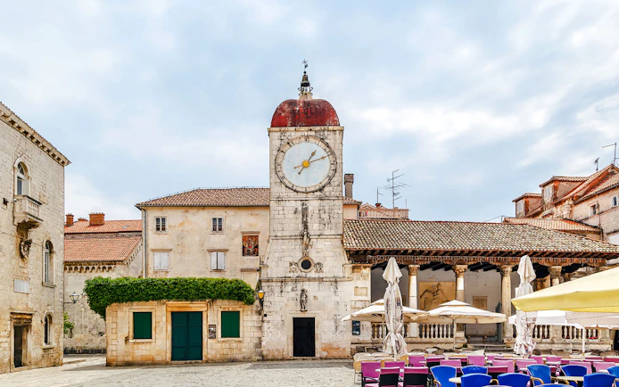 Loggia and clock tower in Trogir, Croatia, with surrounding historic buildings.