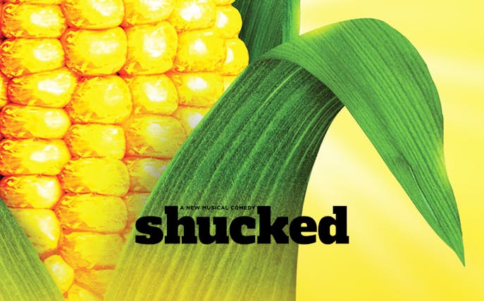 Corn cob with green husk and the word "Shucked" in bold text.