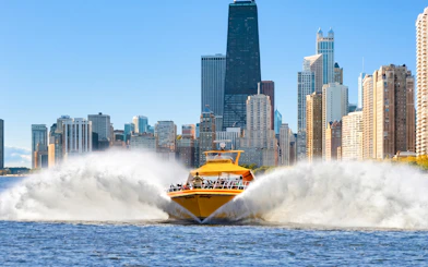 Speedboat on Lake Michigan with Chicago skyline in background.