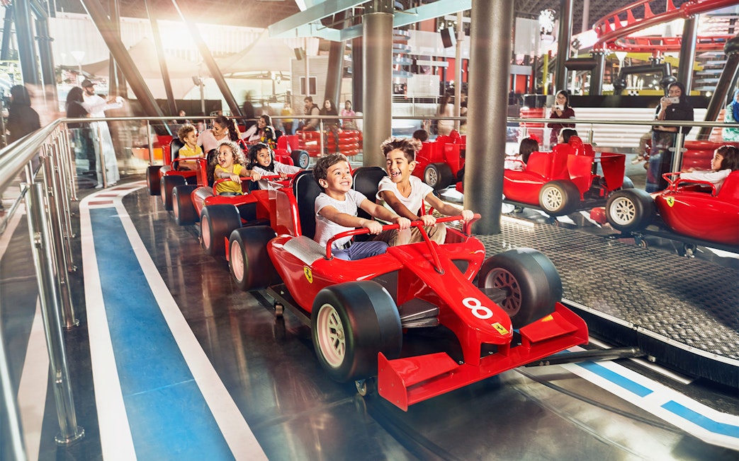 Children driving mini Ferraris at Ferrari World Abu Dhabi.