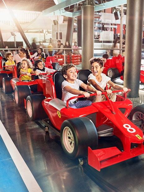 Children driving mini Ferraris at Ferrari World Abu Dhabi.