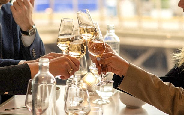 Toasting with champagne at Madame Brasserie, Eiffel Tower, Paris Christmas lunch.
