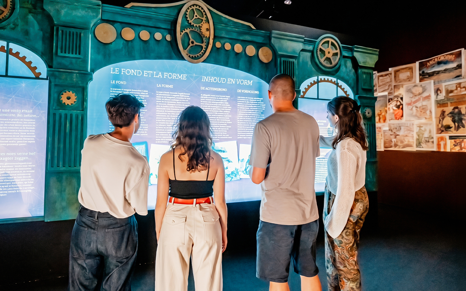 Visitors engaging with interactive Jules Verne 200: Le Voyage immersif exhibit.